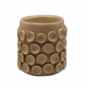 A tan ceramic mug with rows of circular protrusions on its exterior.
