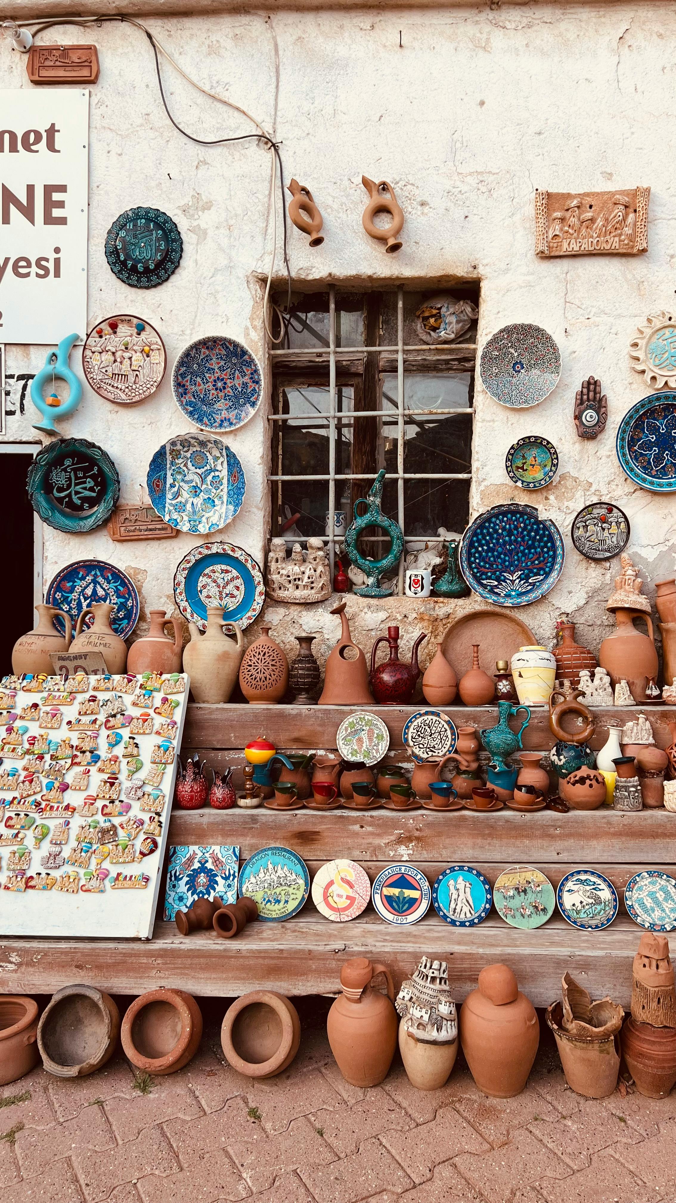 Vibrant collection of traditional pottery and ceramics in a rustic outdoor setting.