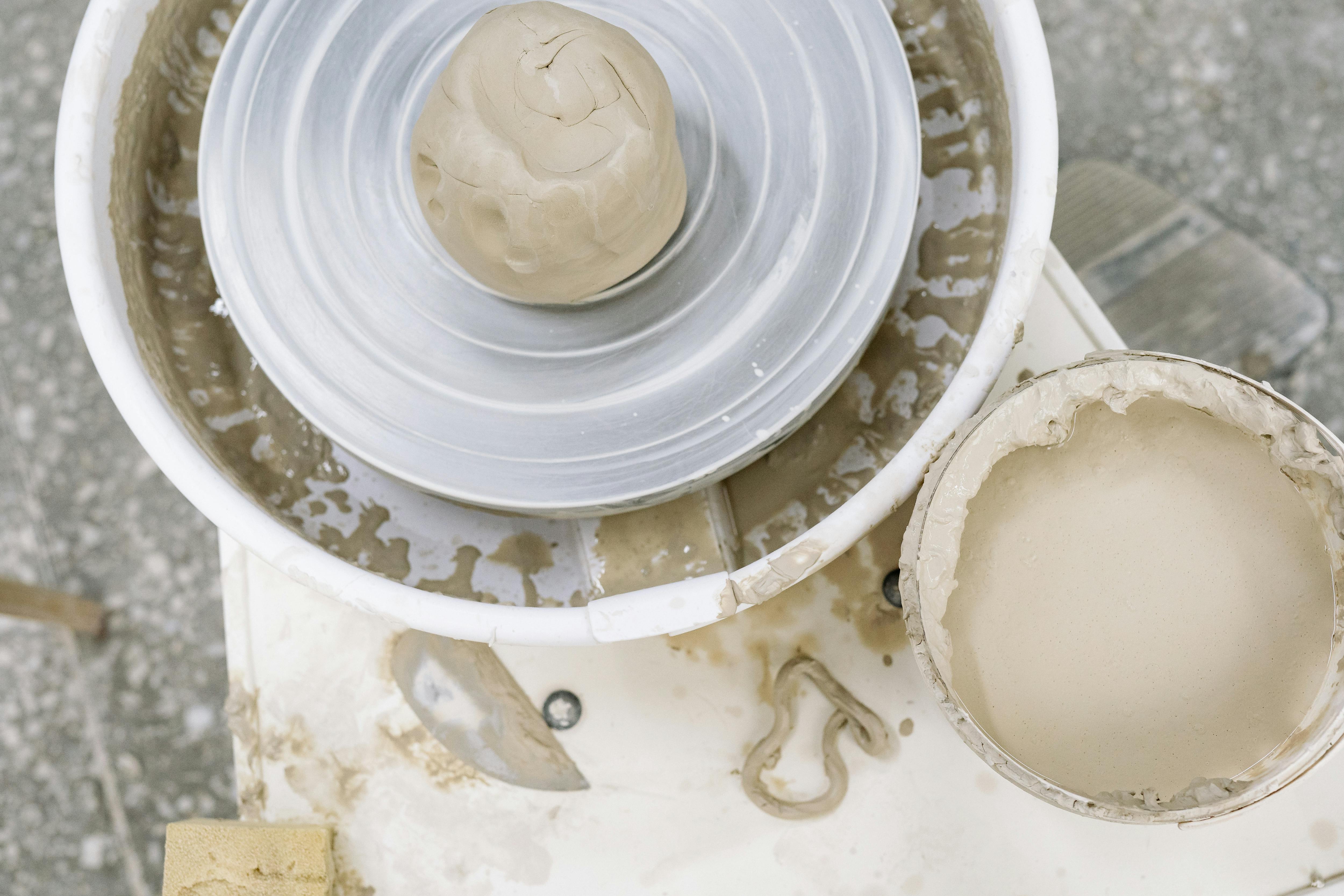 Clay ready on a pottery wheel for shaping, ideal for ceramic art enthusiasts.