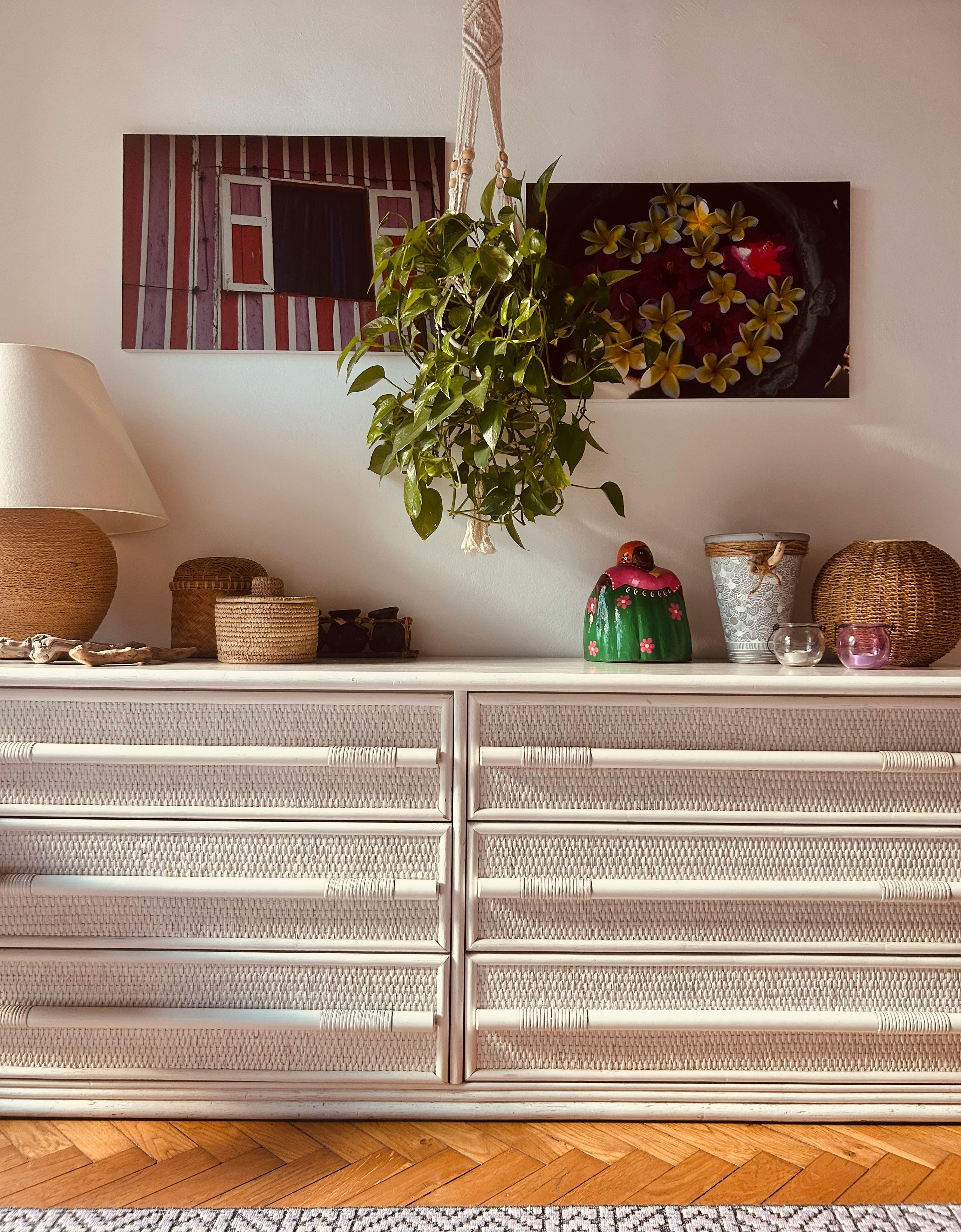 Stylish interior decor with wicker, plants, and vibrant art accent.