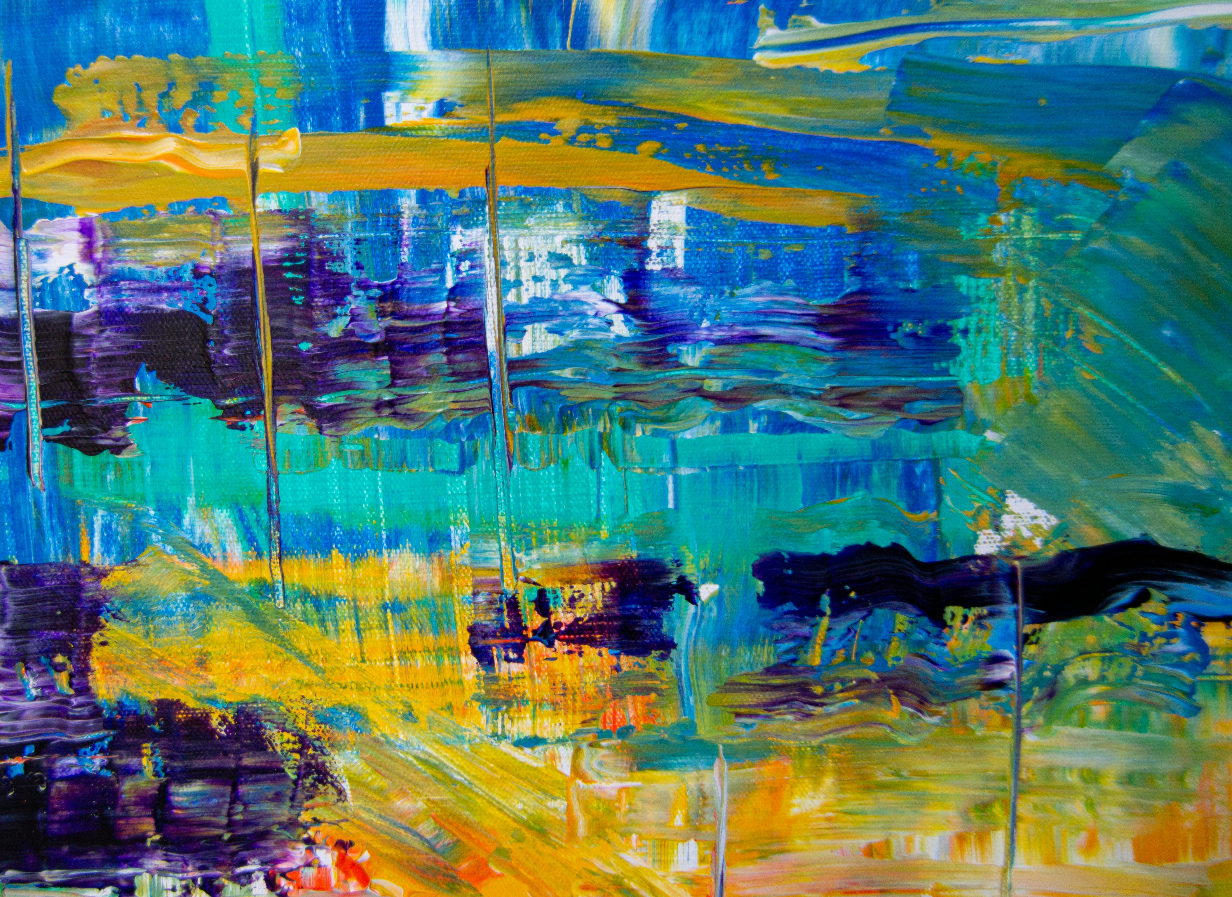 Dynamic abstract painting with vibrant brushstrokes in blue and yellow tones.