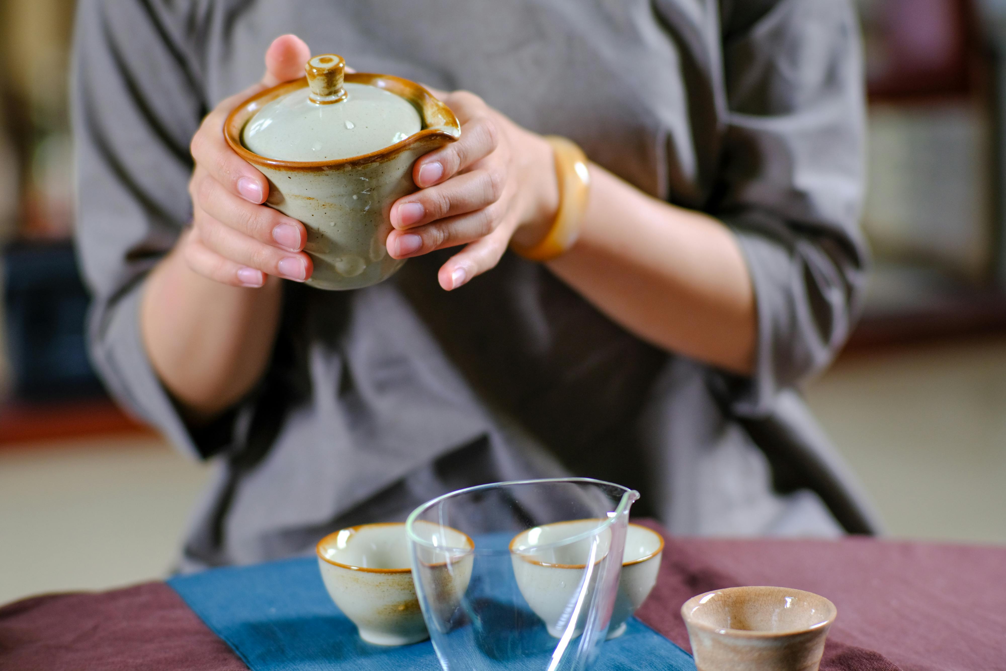 A close-up of a traditional tea ceremony showcasing elegant ceramic teaware and a calming atmosphere.