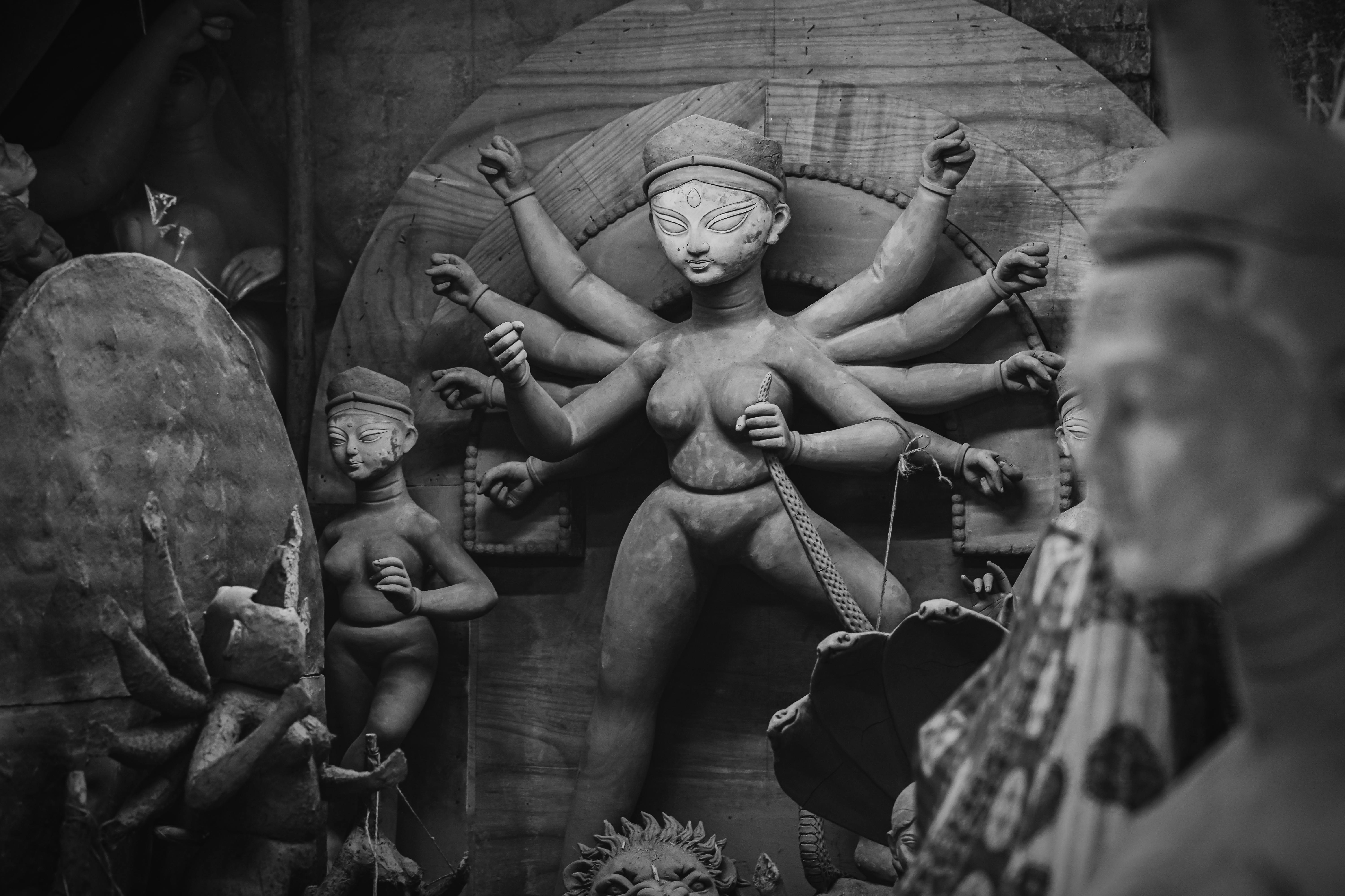 Black and white image of Durga idol crafting in Kumartuli, Kolkata, a vibrant hub of artistry.