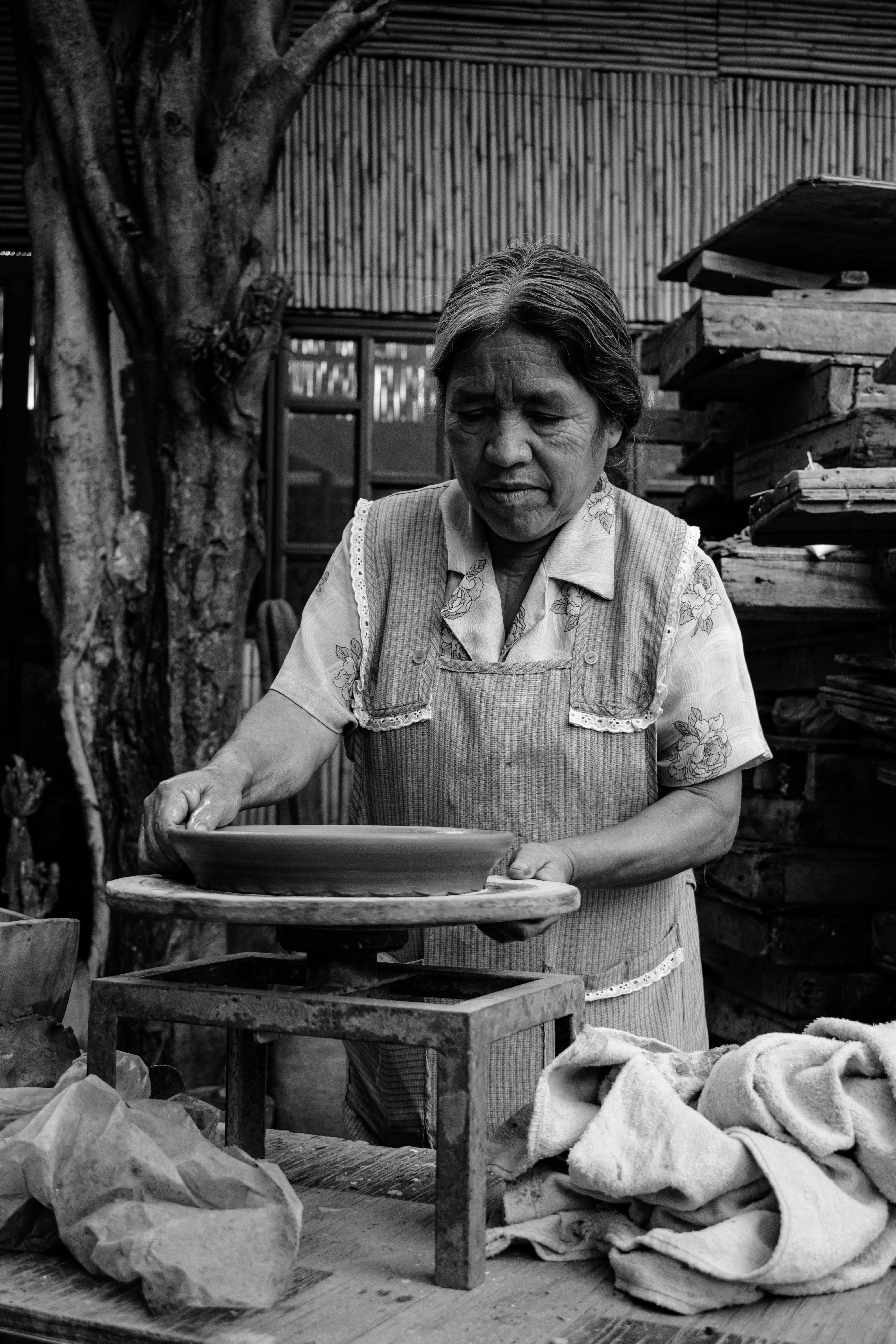 An artisan skillfully crafts pottery in Oaxaca, highlighting Mexican craftsmanship.